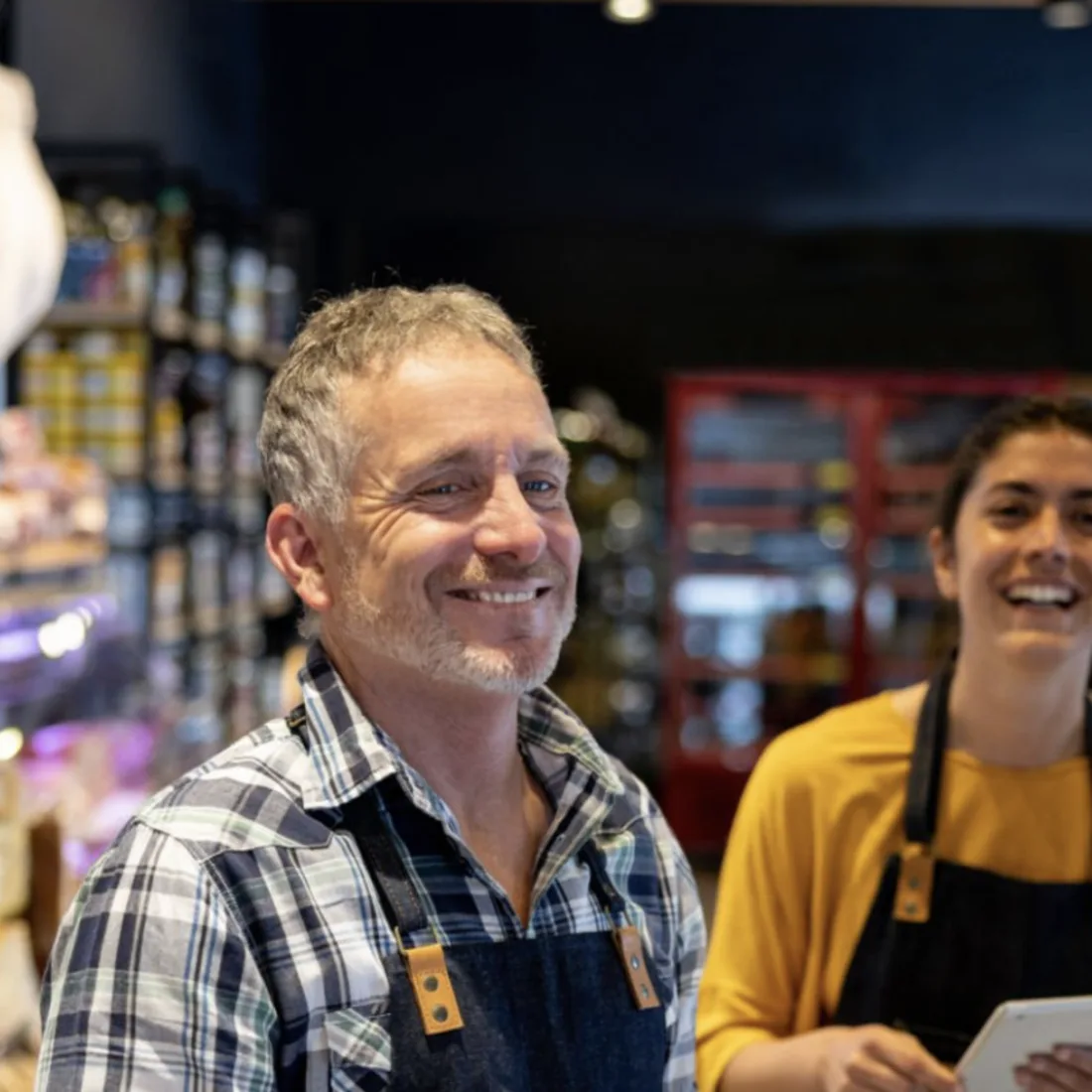 Deli staff serving a customer at the counter