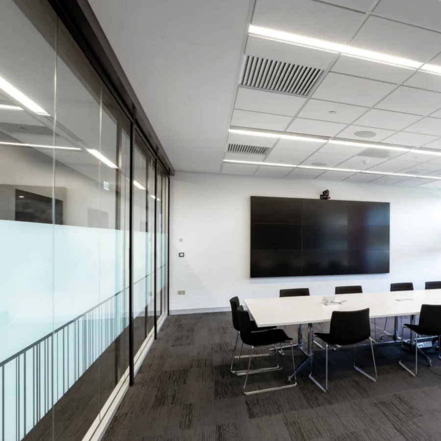 Office boardroom with glass partition and presentation screen